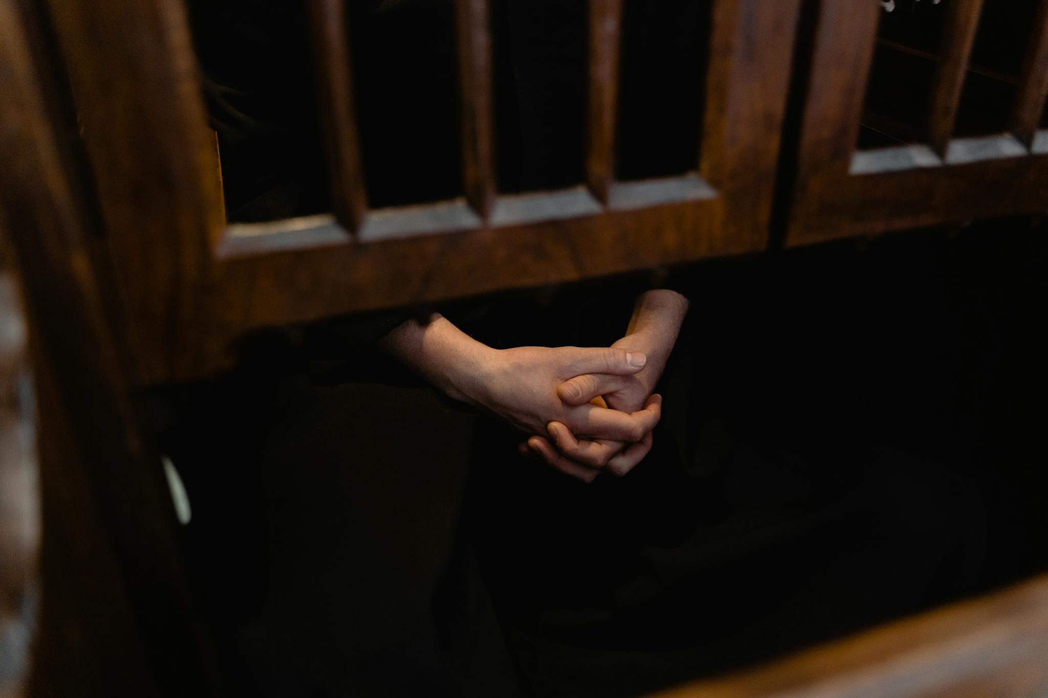 Persons Left Hand on Brown Wooden Staircase